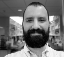 Black and white headshot photo of Dr. Drew Davidson, an F32 award recipient, who used the funding opportunity to investigate context-dependent behaviors in animals. 