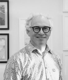 A black and white headshot of Dr. Gordon Fishell in glasses smiling 
